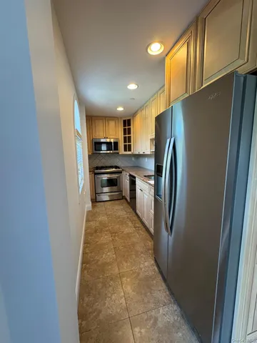 view of a refrigerator in kitchen and a window
