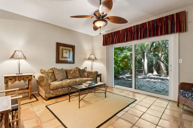a living room with furniture a window and a chandelier