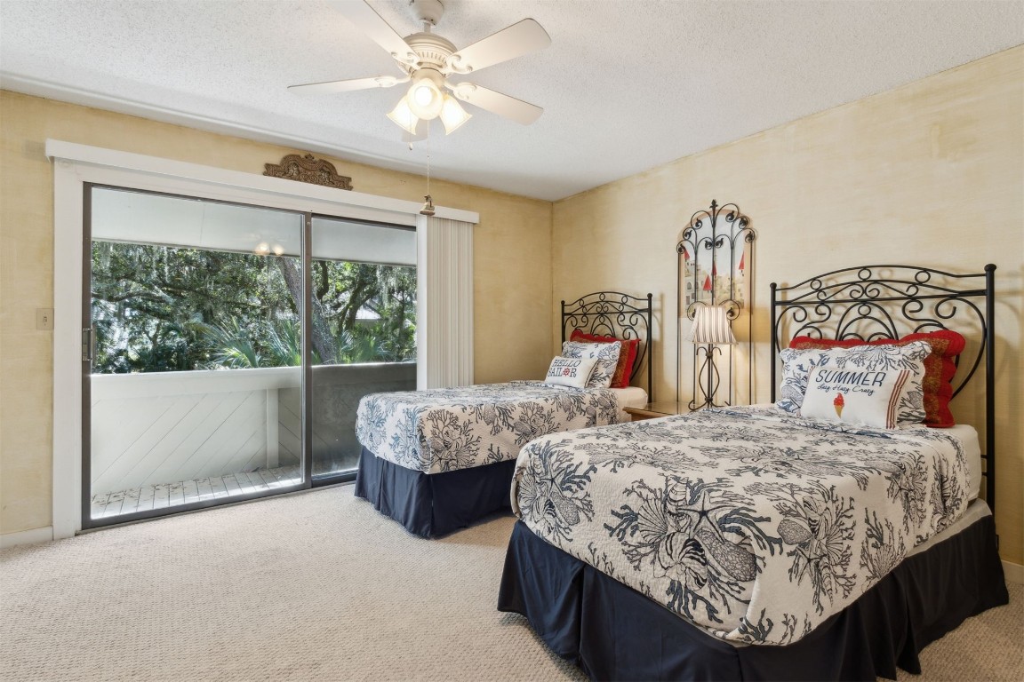 3028 Sea Marsh Road, Unit 3028 Fernandina Beach, FL 32034 - Photo 18 of 39 a bedroom with two beds and a large window