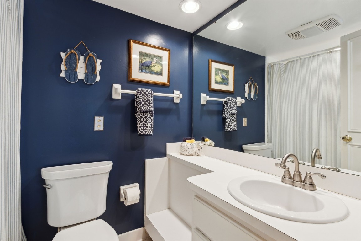 3028 Sea Marsh Road, Unit 3028 Fernandina Beach, FL 32034 - Photo 20 of 39 a bathroom with a toilet a sink and mirror