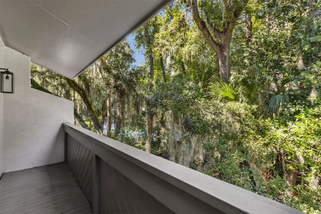 a view of a house with potted plants in front of door