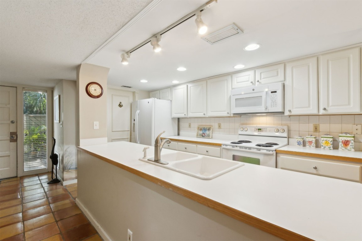 3028 Sea Marsh Road, Unit 3028 Fernandina Beach, FL 32034 - Photo 7 of 39 a large kitchen with stainless steel appliances granite countertop a sink and a refrigerator