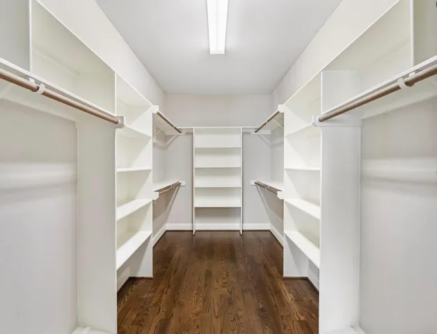 a view of walk in closet with empty racks