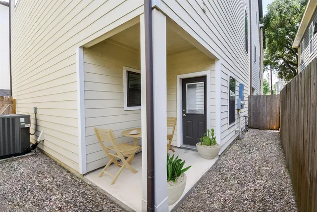 a view of a brick house with plants