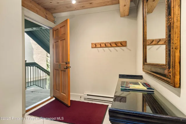 a view of a livingroom with wooden floor and a rug