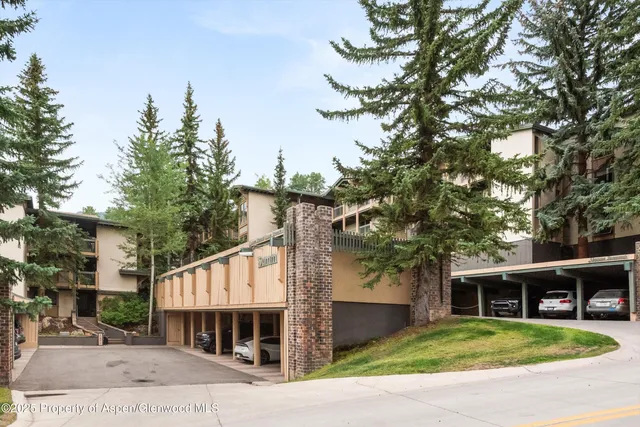 a front view of house with yard and trees