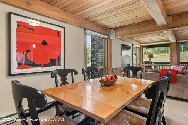 a view of a dining room with furniture and window