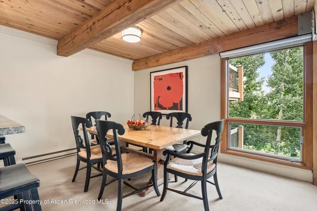 a dining room with furniture and window