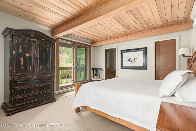 a bedroom with a bed next to a window