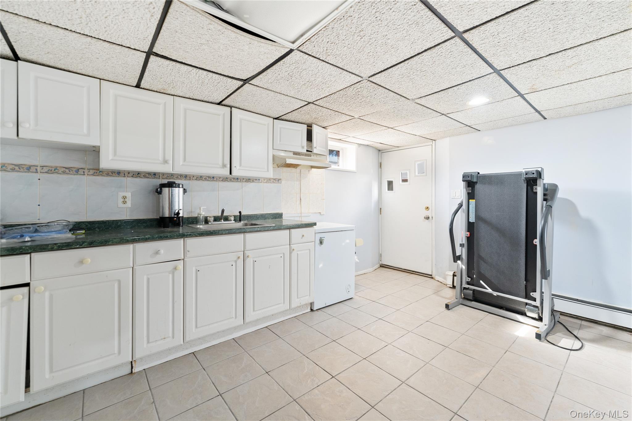 90 27th Street Copiague, NY 11726 - Photo 14 of 18 a kitchen with stainless steel appliances granite countertop a sink a stove a refrigerator and cabinets