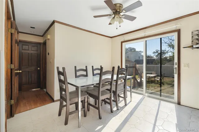 a dining room with furniture and a floor to ceiling window