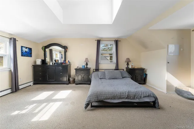 a bedroom with a bed and a wooden floor