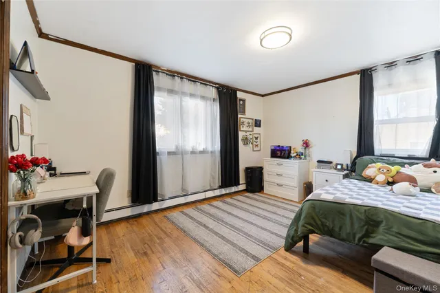 a bedroom with bed and a large window