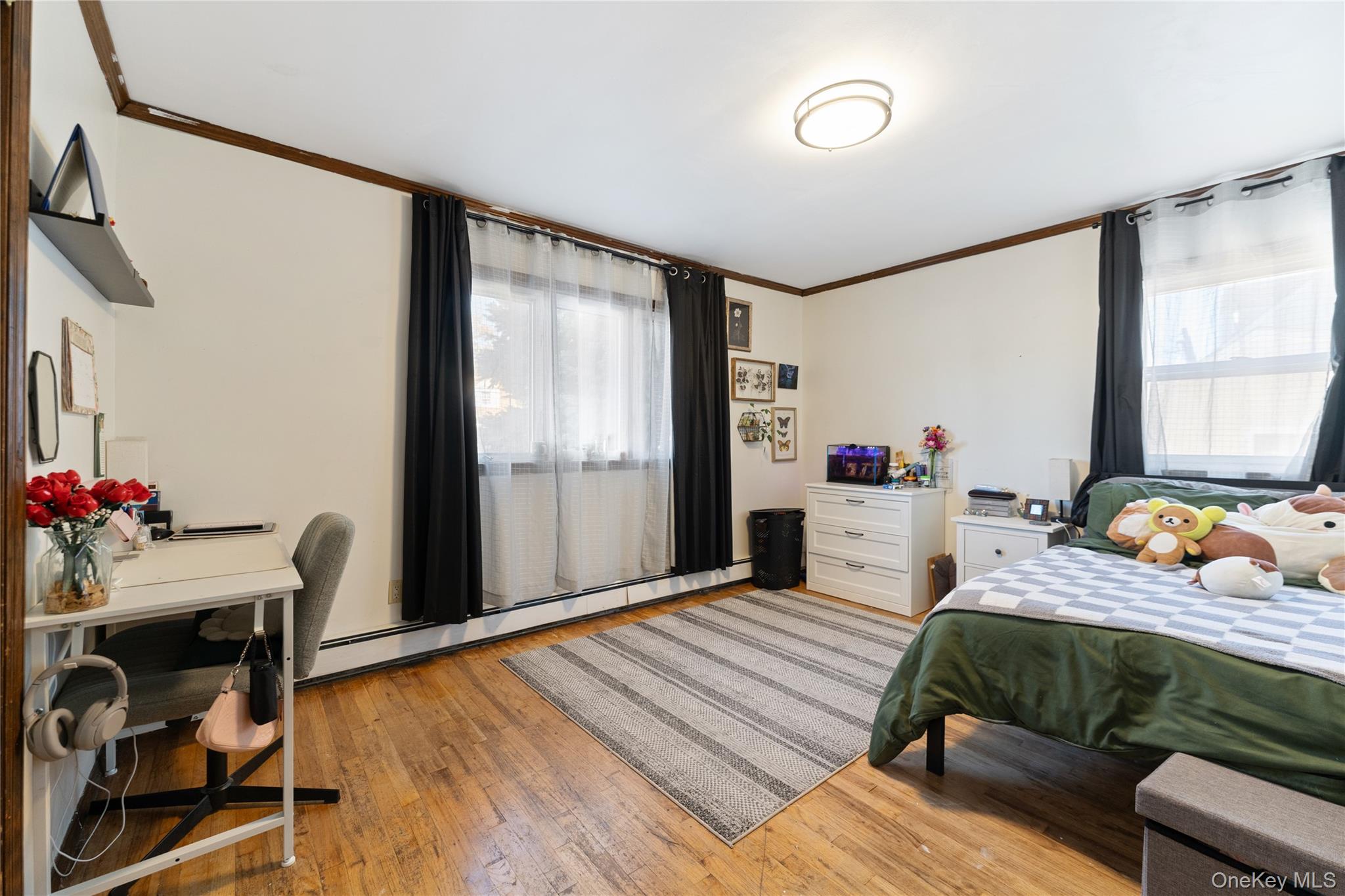 90 27th Street Copiague, NY 11726 - Photo 7 of 18 a bedroom with furniture and a window