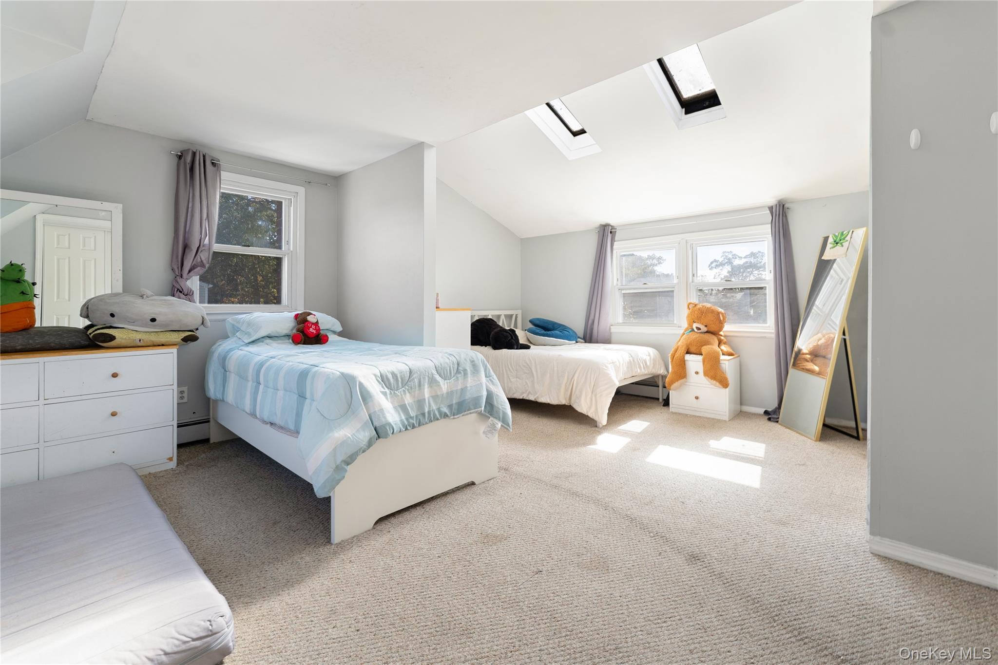 90 27th Street Copiague, NY 11726 - Photo 8 of 18 a bedroom with bed and a large window