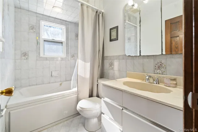 a bathroom with a sink toilet and a mirror
