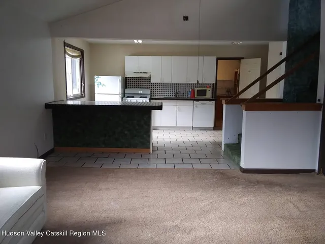 a view of kitchen with furniture and window