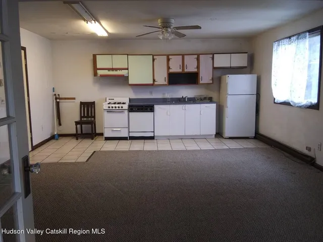 a living room with stainless steel appliances kitchen island granite countertop furniture and a kitchen view