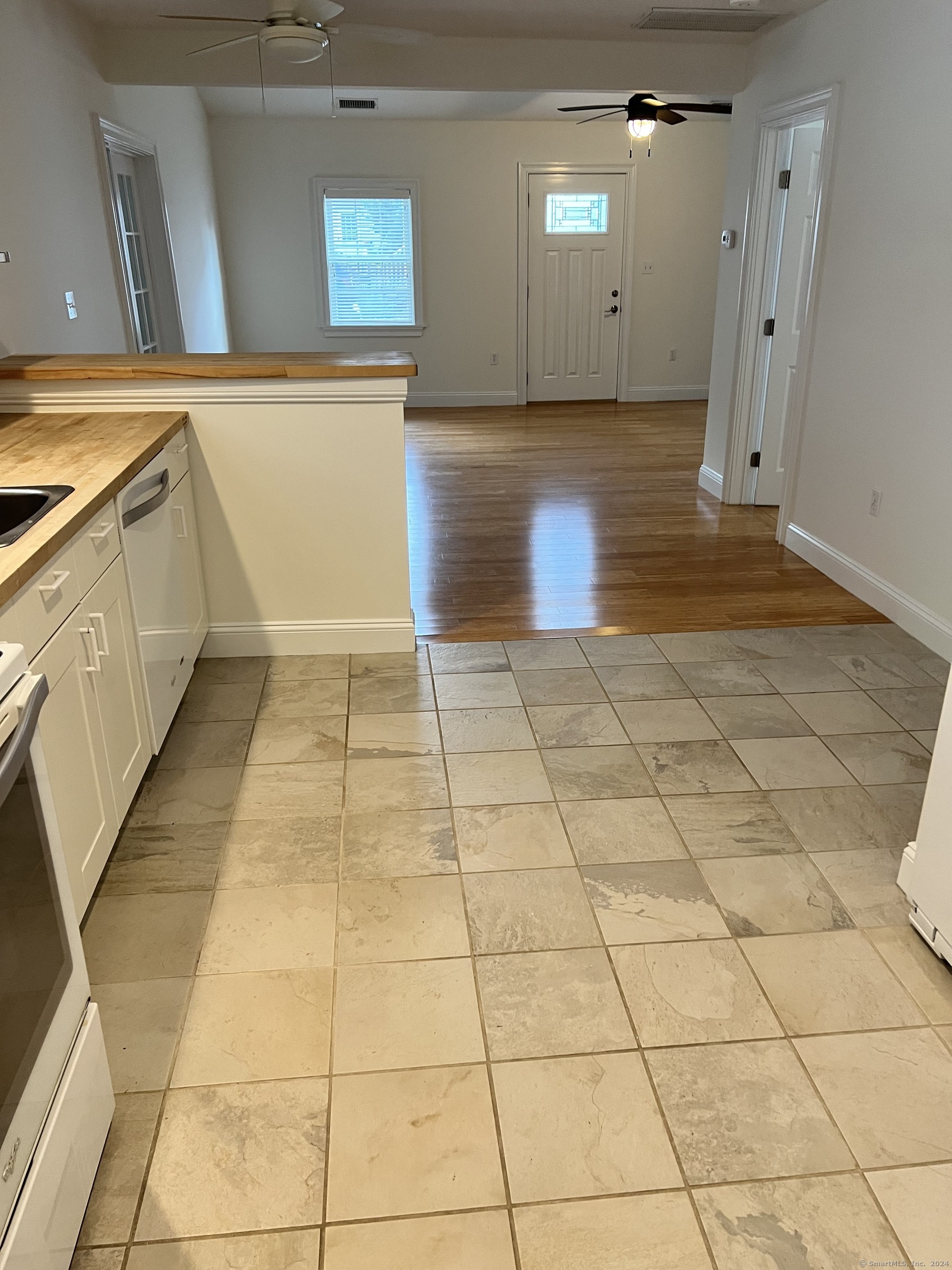 170 Shore Road Clinton, CT 06413 - Photo 11 of 20 a view of a kitchen with stainless steel appliances a sink and cabinets