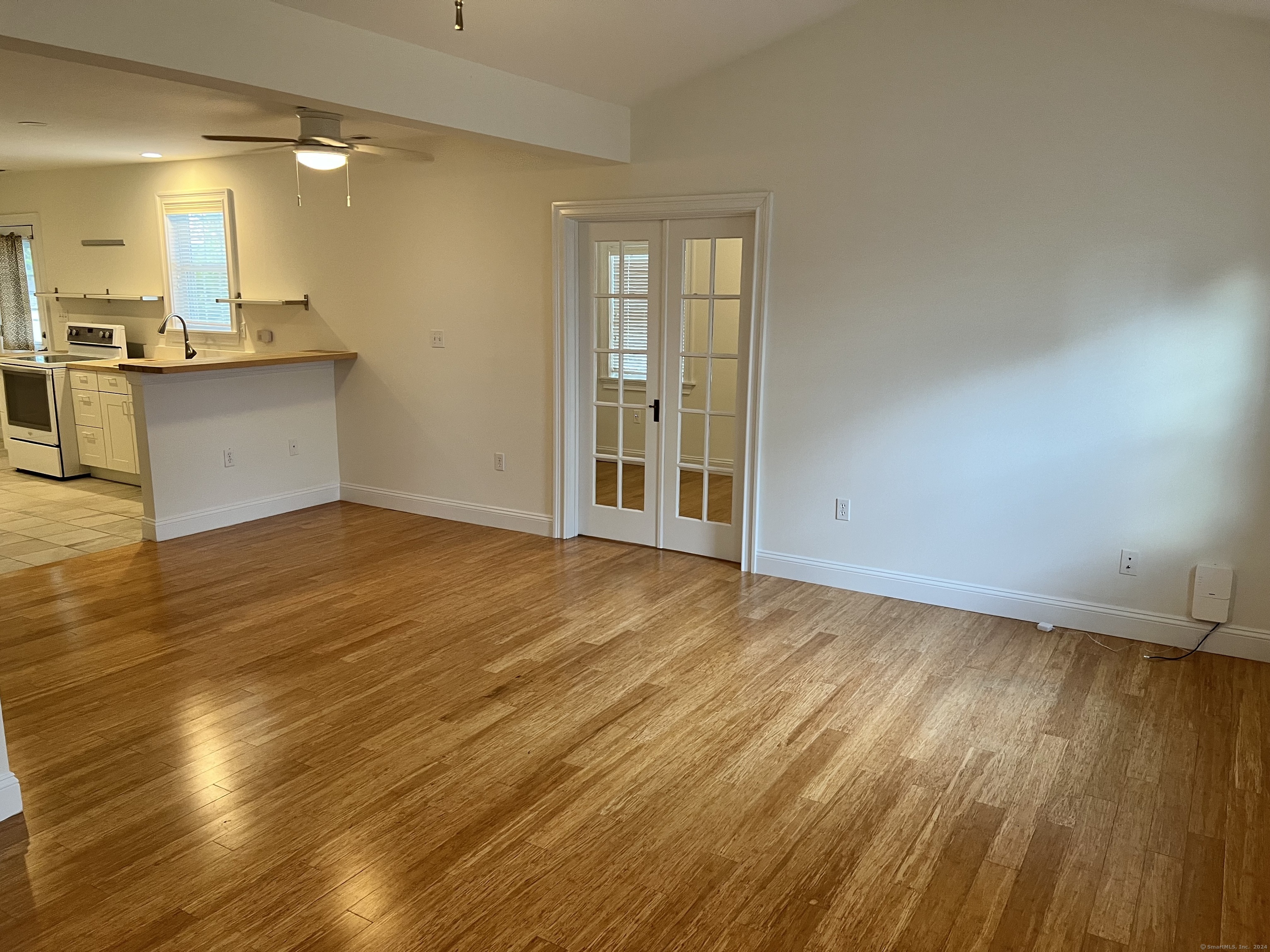 170 Shore Road Clinton, CT 06413 - Photo 13 of 20 an empty room with wooden floor and windows