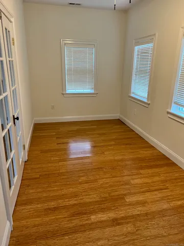 wooden floor in an empty room with a window