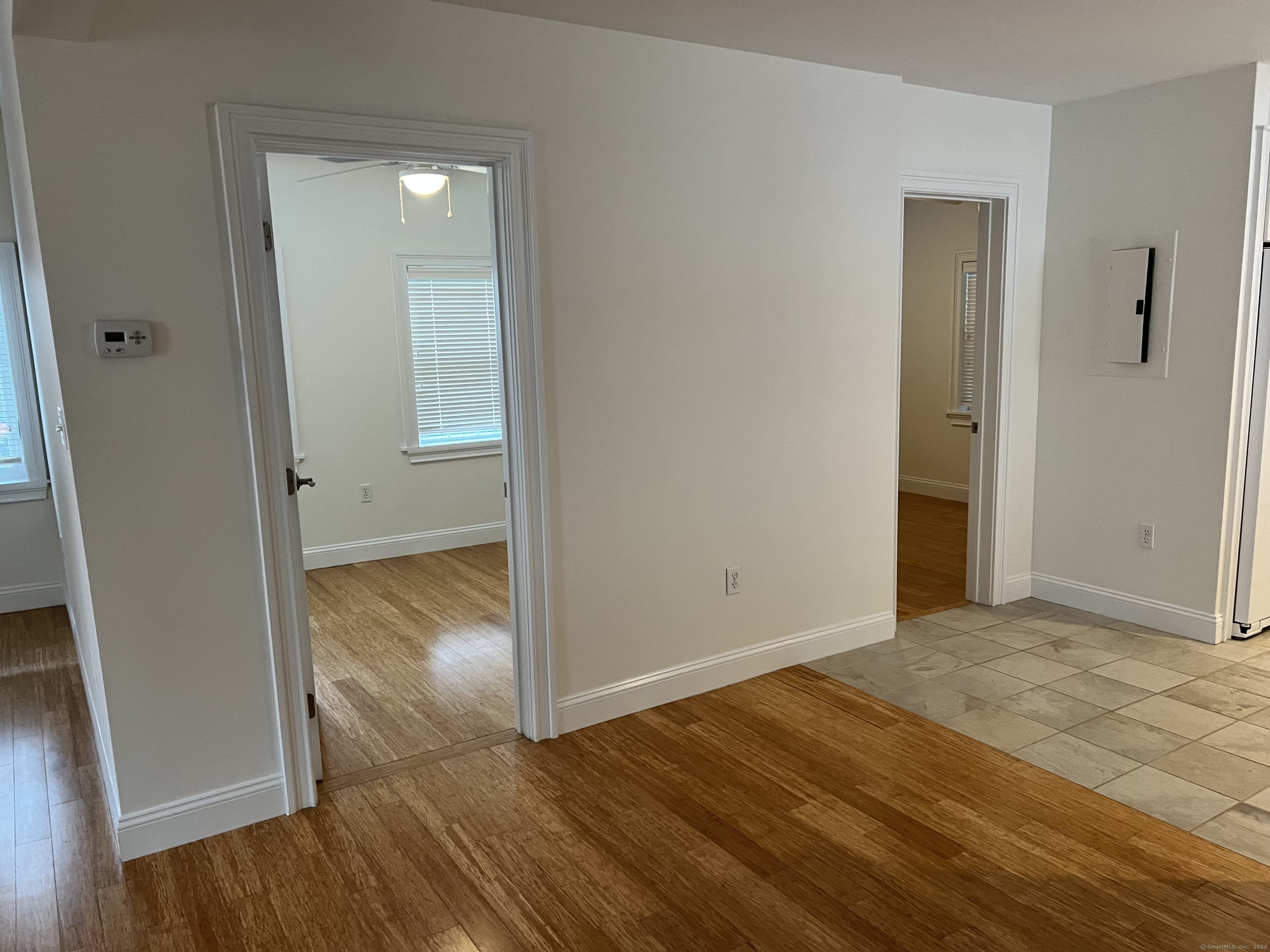170 Shore Road Clinton, CT 06413 - Photo 16 of 20 an empty room with wooden floor and entrance