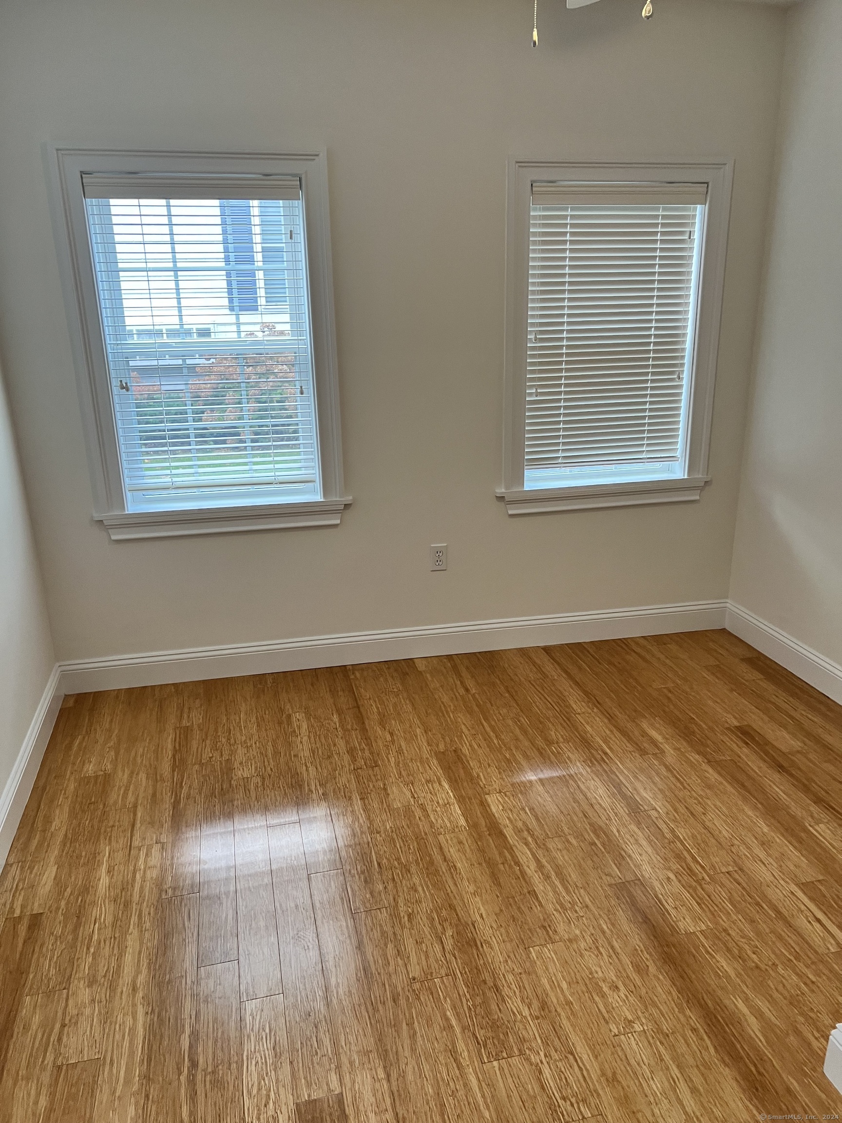 170 Shore Road Clinton, CT 06413 - Photo 18 of 20 a view of an empty room with wooden floor and a window