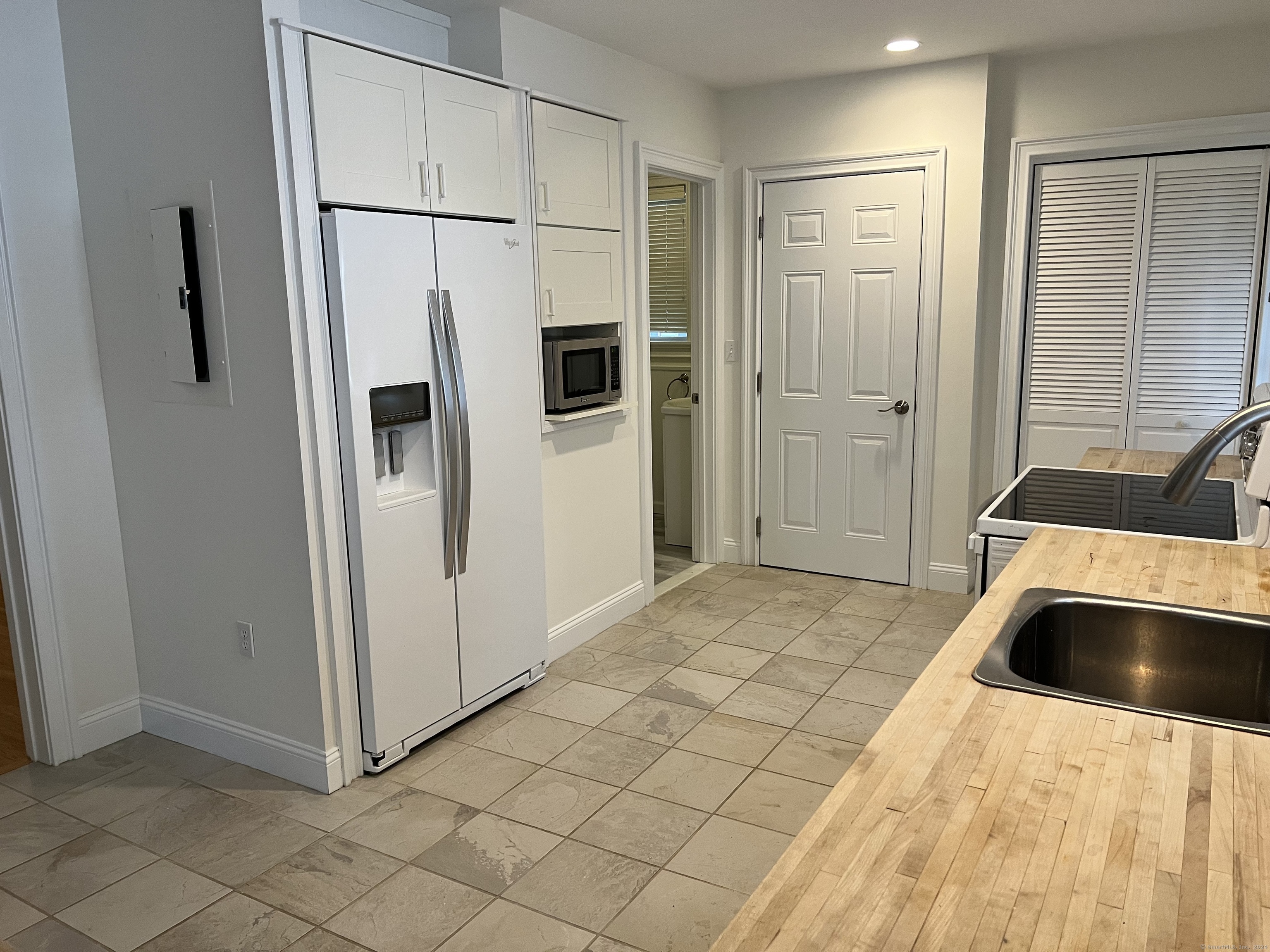 170 Shore Road Clinton, CT 06413 - Photo 9 of 20 a view of a kitchen with a sink and refrigerator