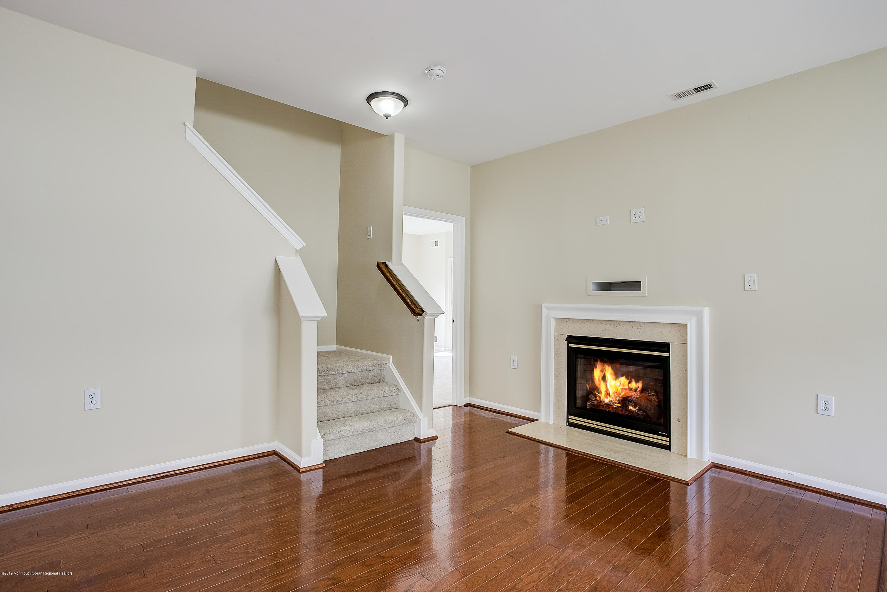 25 Torino Road Manchester Township, NJ 08759 - Photo 11 of 31 a view of an empty room with wooden floor fireplace and a window