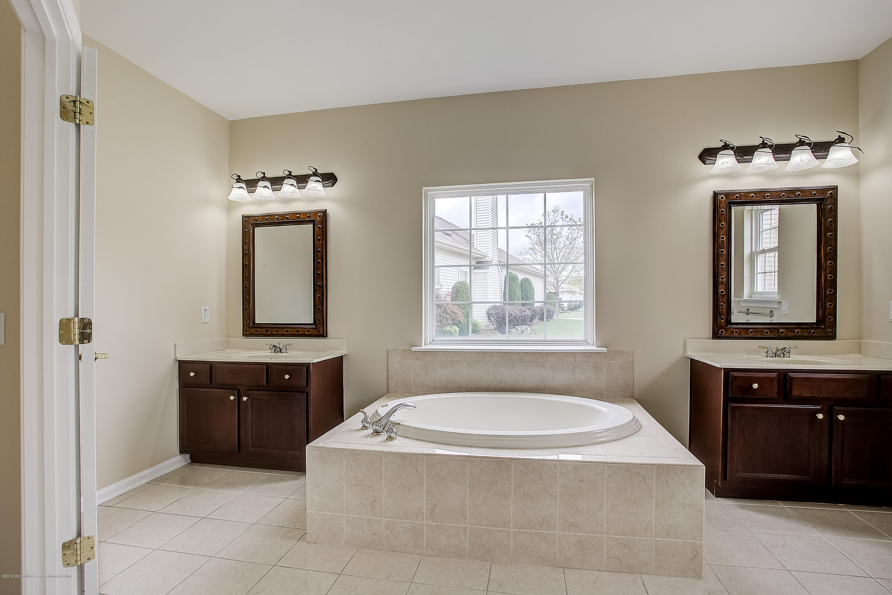 25 Torino Road Manchester Township, NJ 08759 - Photo 23 of 31 a bathroom with a tub sink and mirror
