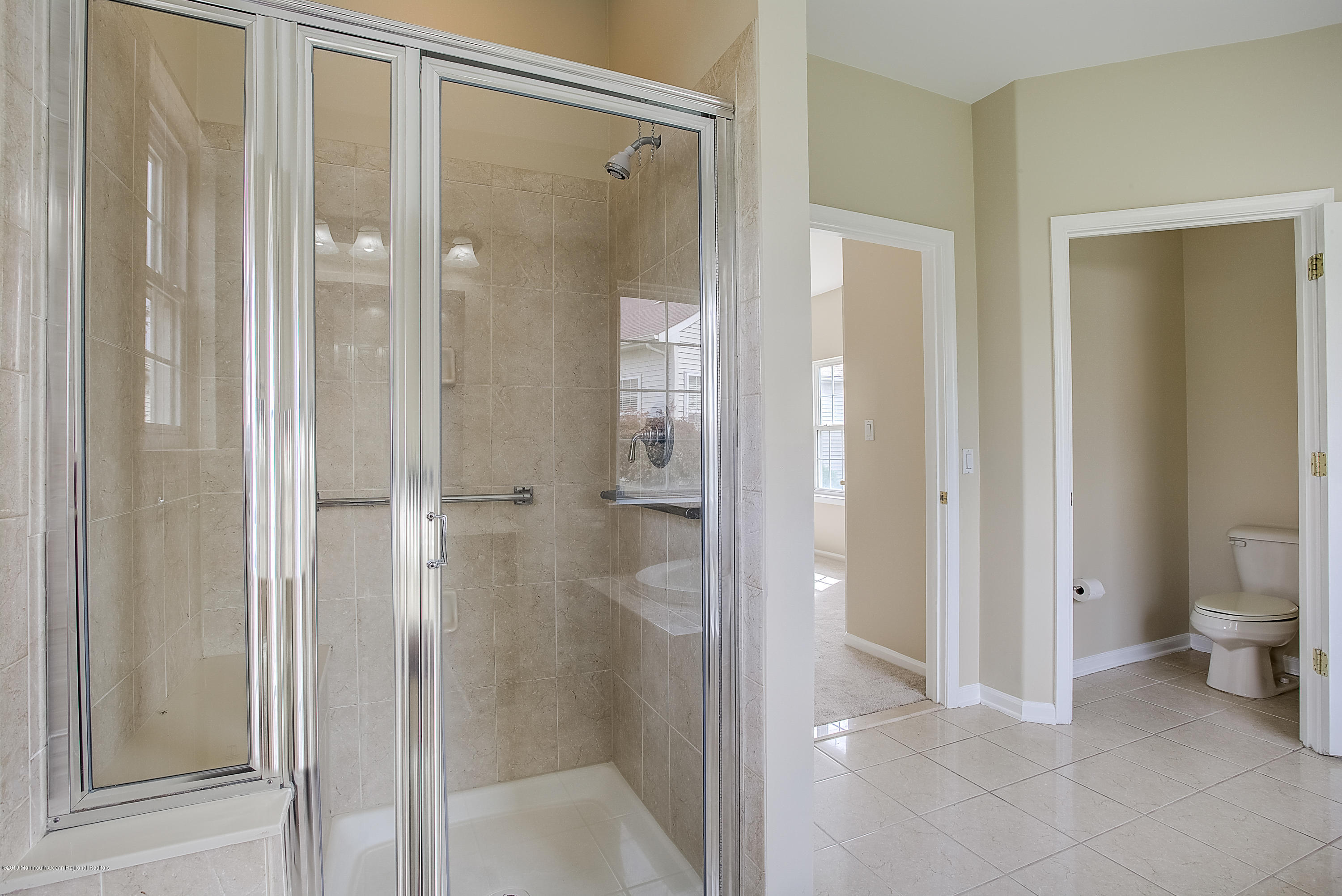 25 Torino Road Manchester Township, NJ 08759 - Photo 24 of 31 a bathroom with a shower and a glass door