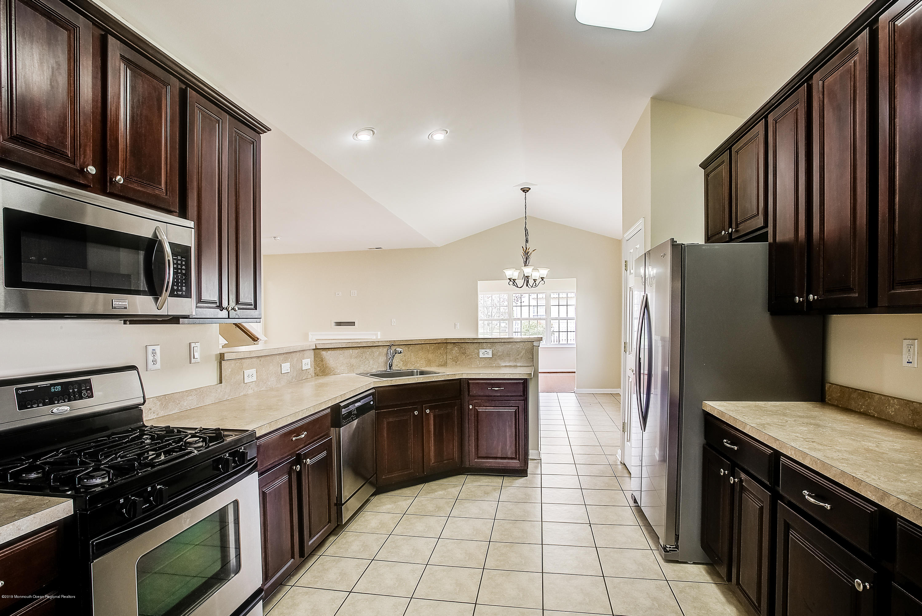 25 Torino Road Manchester Township, NJ 08759 - Photo 6 of 31 a kitchen with stainless steel appliances granite countertop a stove a sink and a refrigerator