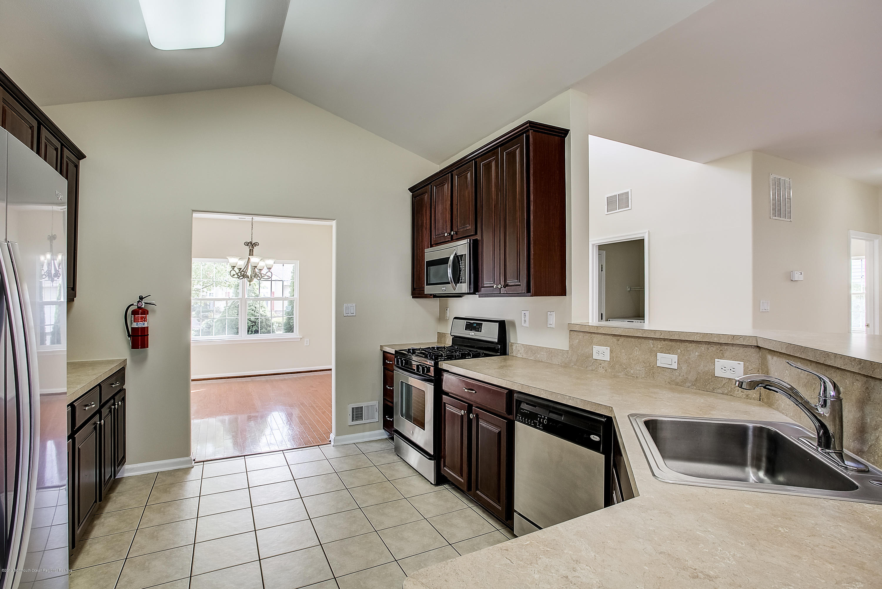 25 Torino Road Manchester Township, NJ 08759 - Photo 7 of 31 a kitchen with stainless steel appliances granite countertop a sink stove and refrigerator