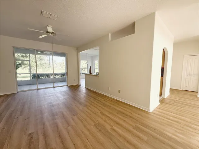 a view of a big room with wooden floor and cabinet