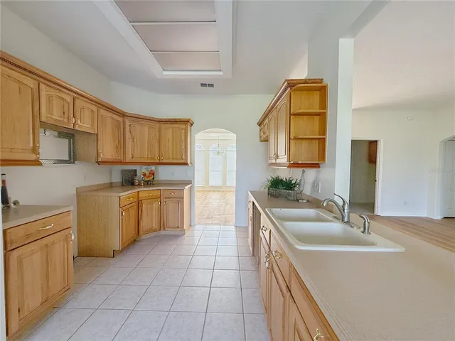 a kitchen with a sink stove and cabinets