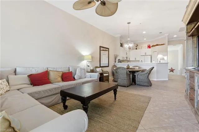 a living room with lots of furniture and kitchen view