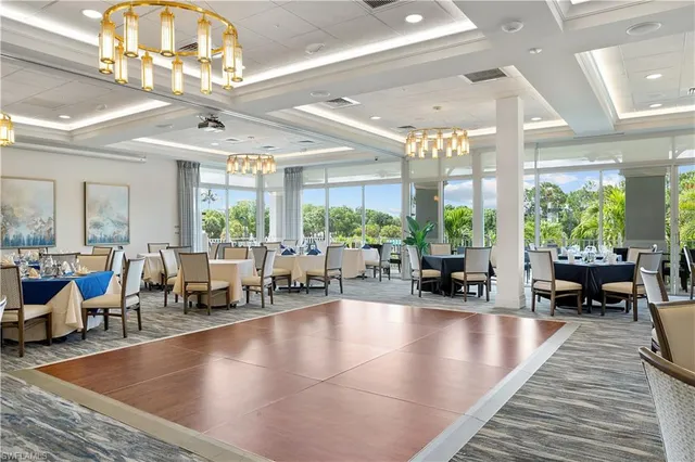 a living room with furniture and large windows