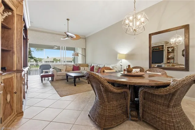 a view of a dining room with furniture a chandelier and wooden floor
