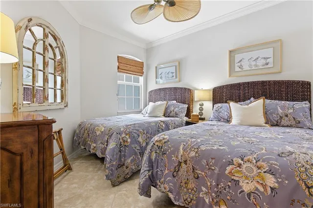 a bedroom with two beds and a window