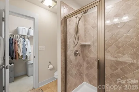 a bathroom with a glass shower door