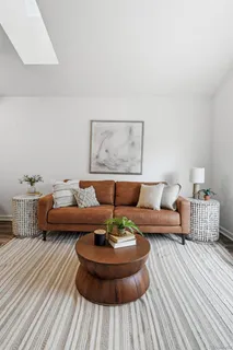 a living room with furniture and a lamp