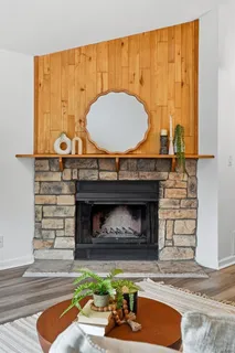 a living room with fireplace furniture and a fireplace