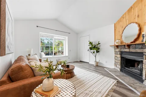 a living room with furniture a window and a fireplace