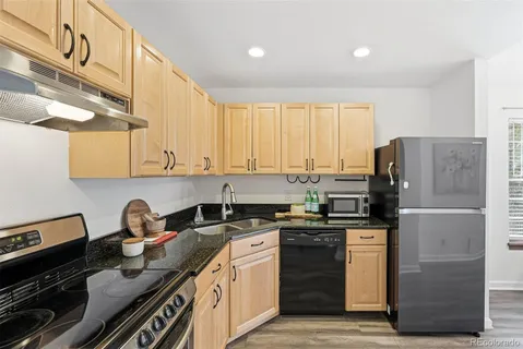 a kitchen with a sink cabinets and stainless steel appliances