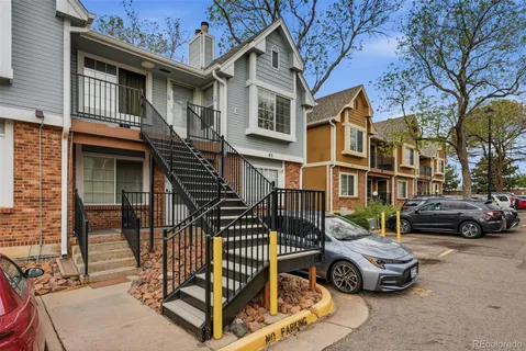 front view of residential houses with cars parked
