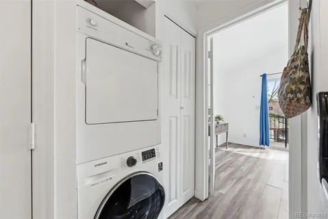 a view of washer and dryer with bathroom in the background