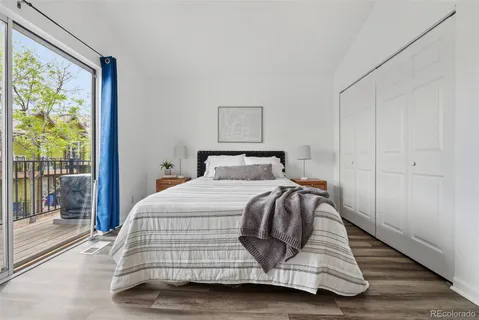 a bedroom with a bed and glass window