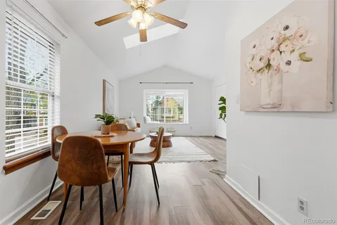 a view of a dining room with furniture and wooden floor