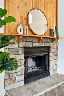 a fireplace with a vase of flowers on it