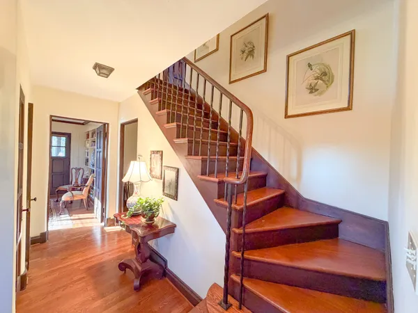 a view of entryway and hall with wooden floor